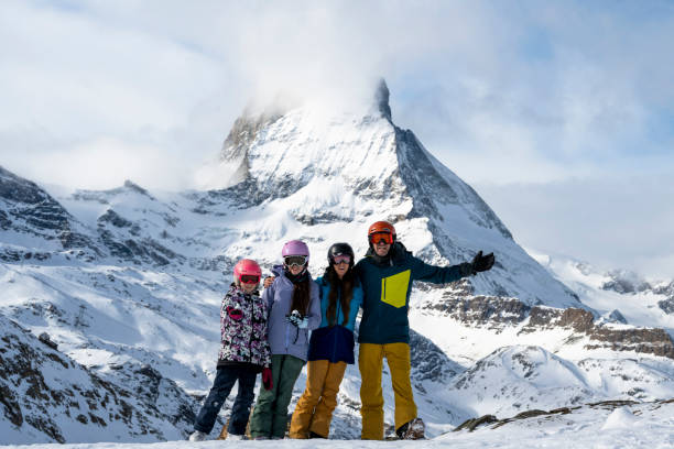Portrait of family on ski slope below Matterhorn mountain